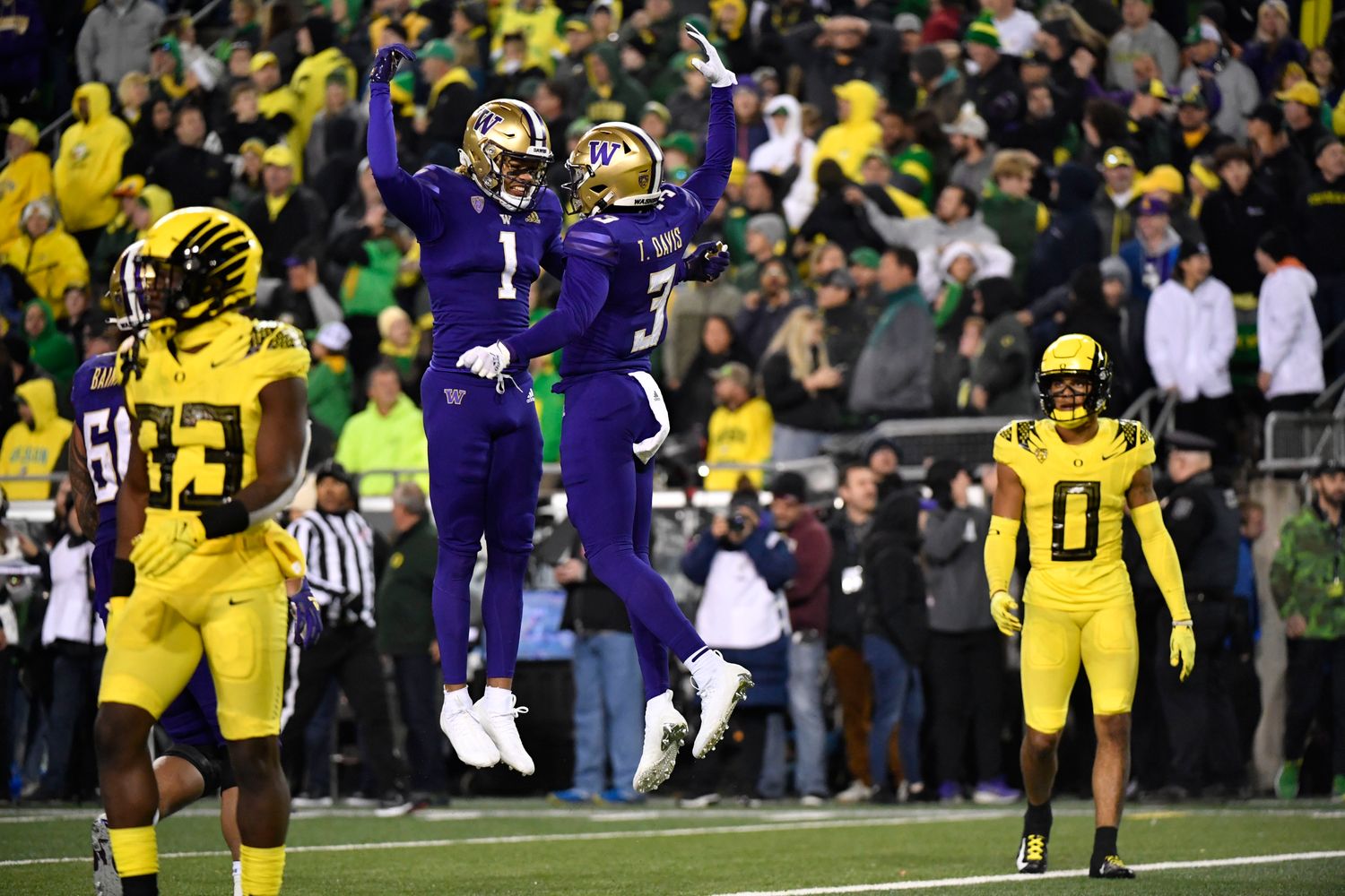 Washington wide receiver Taj Davis celebrates with wide receiver Rome Odunze after scoring in the second half.